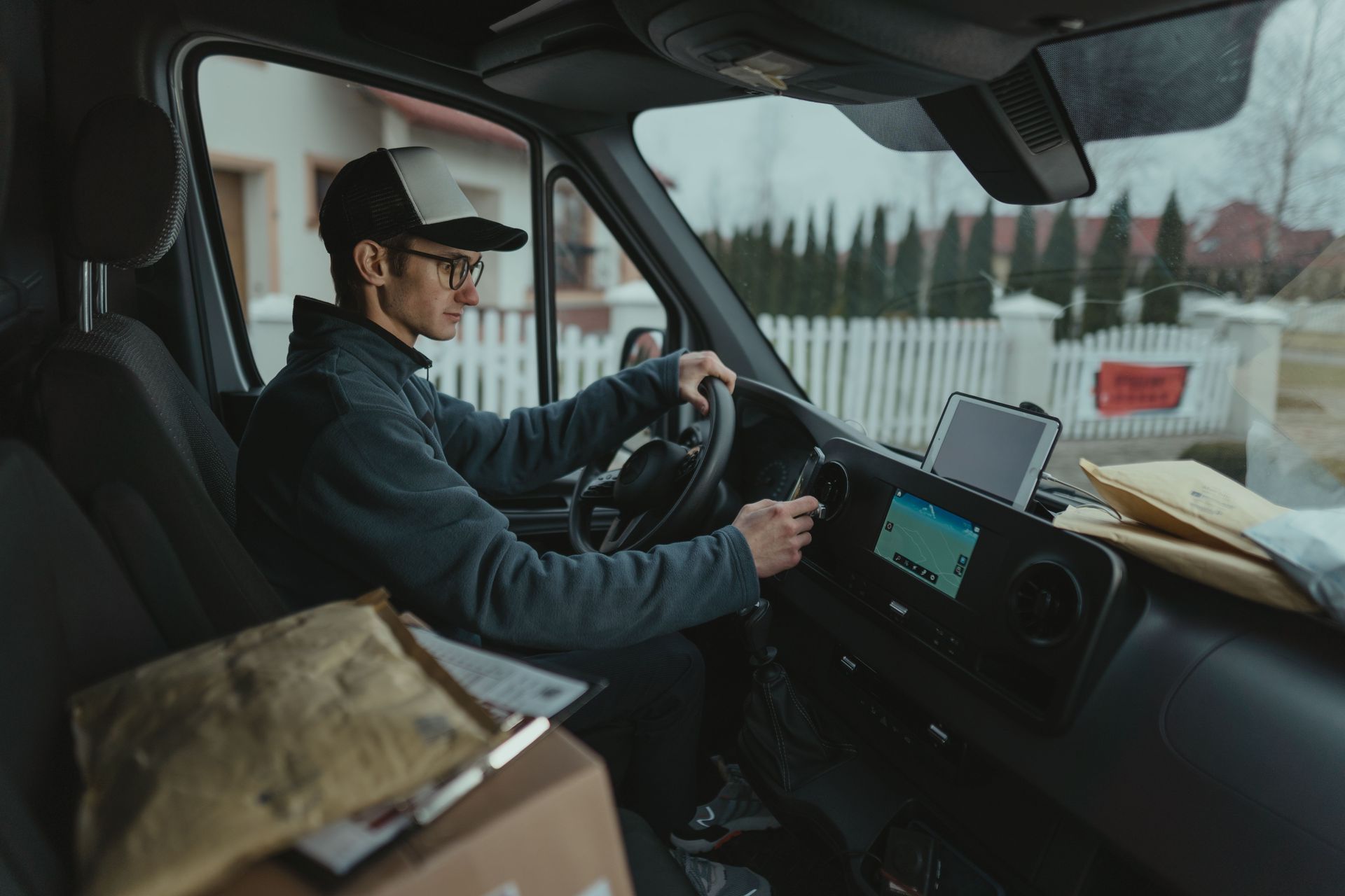 Delivery driver at the wheel of a commercial van with packages, a common business use covered by Arizona commercial auto insurance