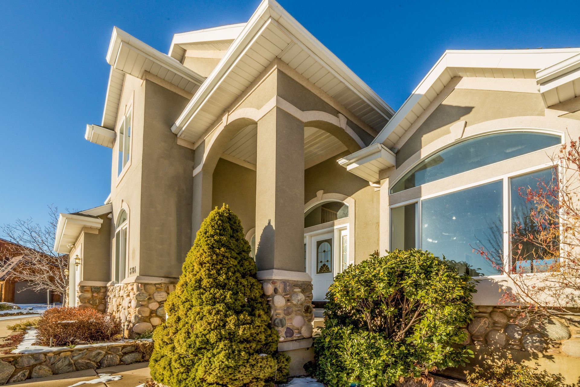 Arizona stucco home exterior with arched windows, illustrating home insurance coverage essentials