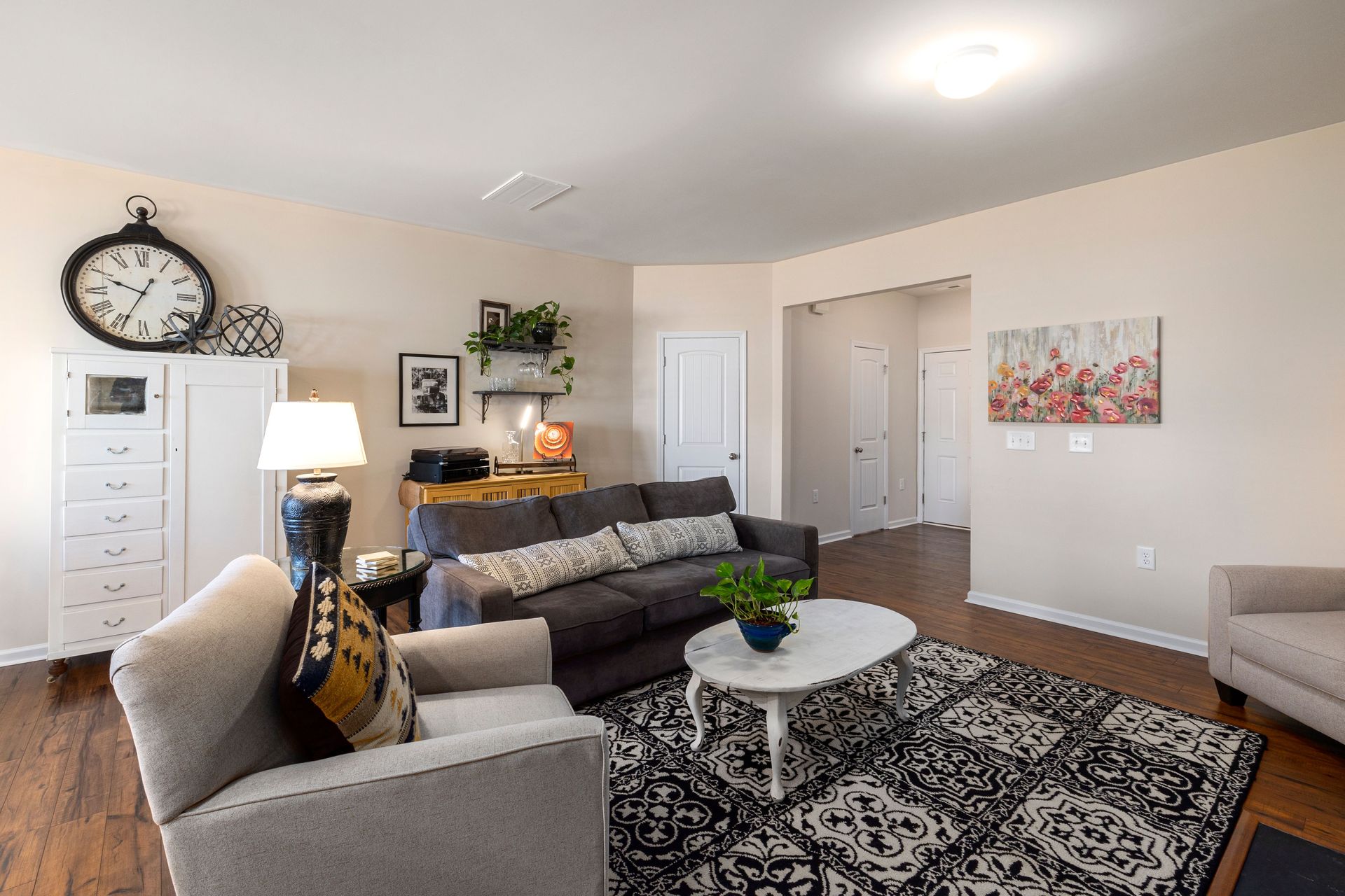 Bright apartment living room with a gray couch and rug, the kind of space Arizona renters protect with renters insurance