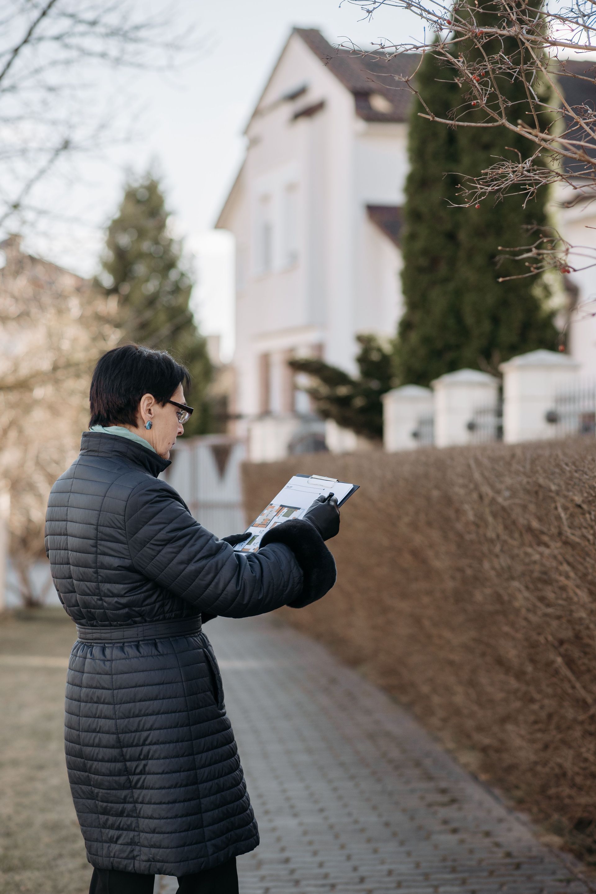 Inspector reviewing hail damage notes outside a Phoenix area home in Arizona