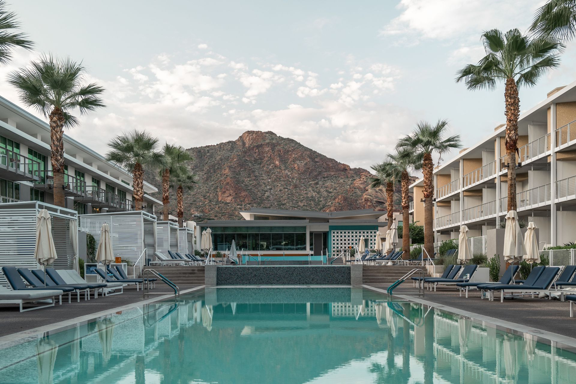 Arizona short-term rental pool courtyard with palm trees and a desert mountain backdrop