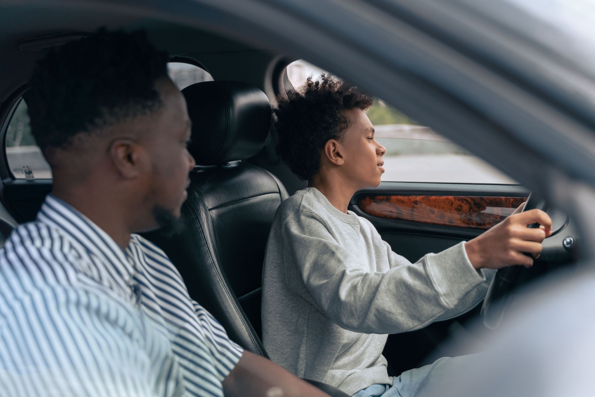 Arizona parent talking with a teen driver about car insurance in Tempe
