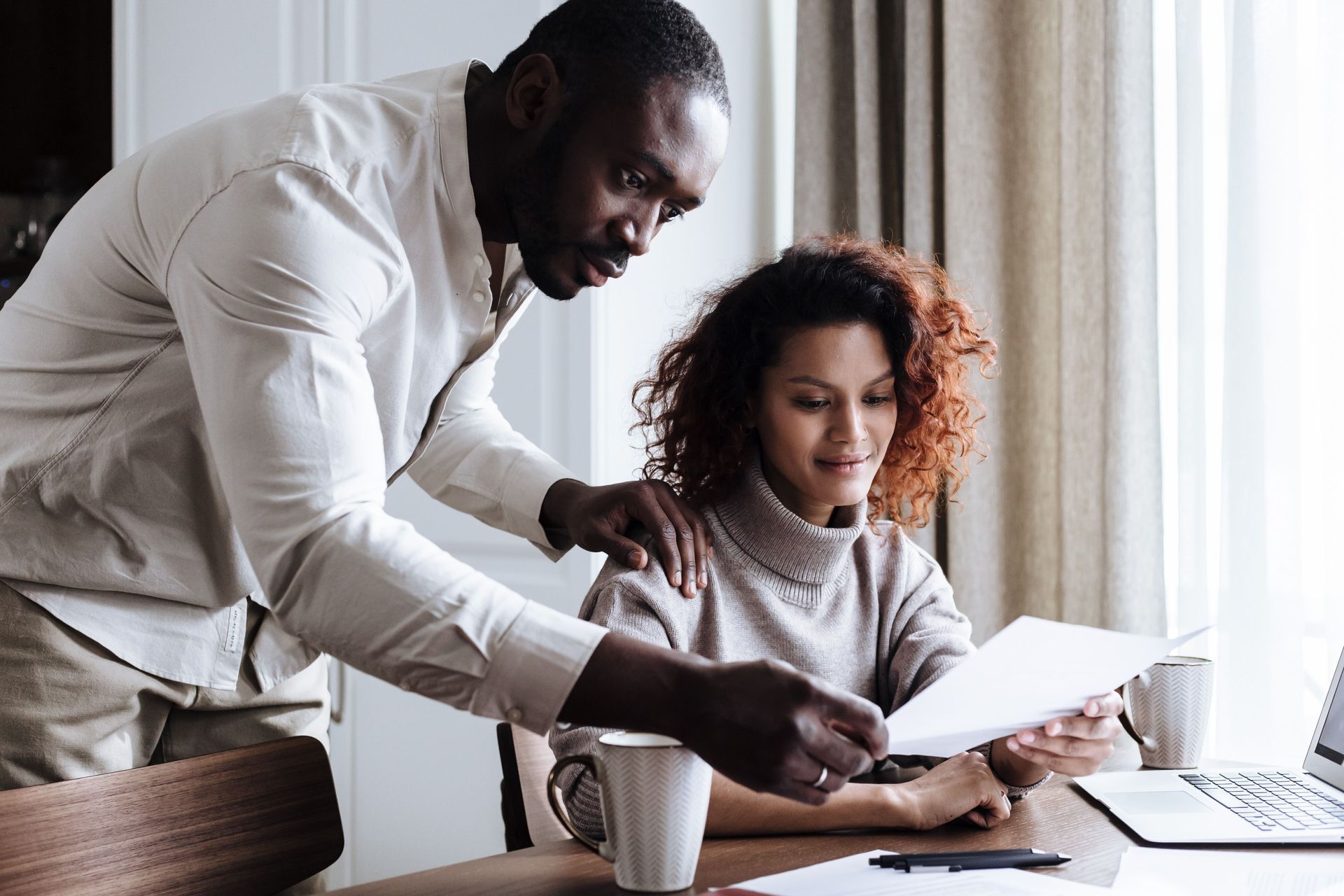 Arizona couple reviewing their Progressive home insurance policy documents together at the kitchen table