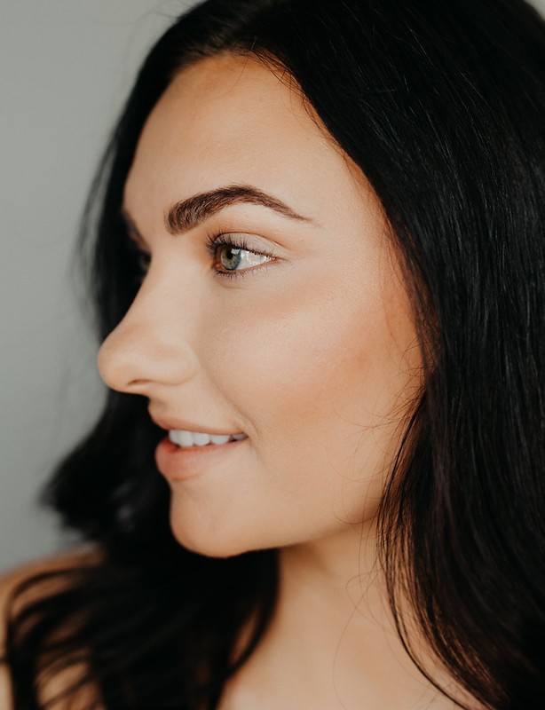 A close up of a woman 's face with a smile on her face.