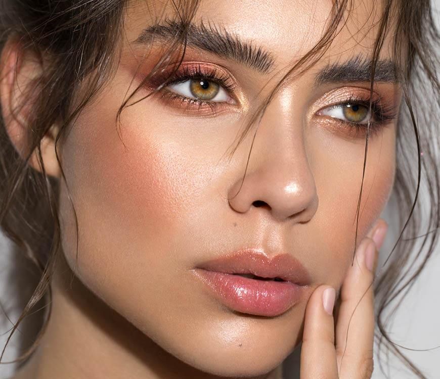 A close up of a woman 's face with makeup on.