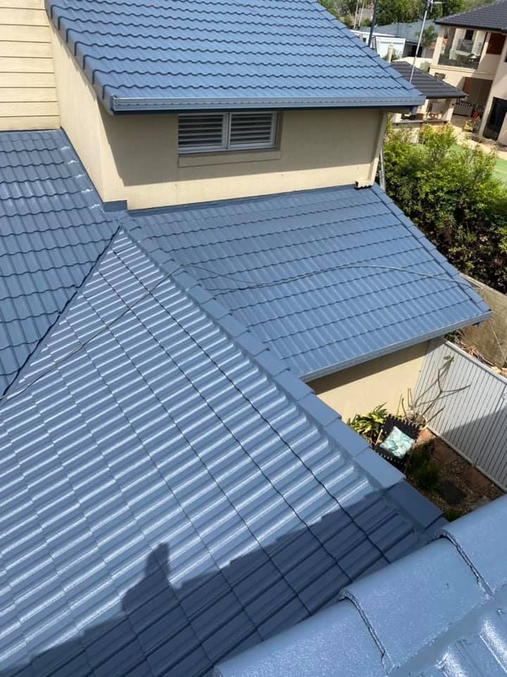 Blue Tiled Roof of A Two-Story Building — SEQ Roofing & Painting in Nerang, QLD