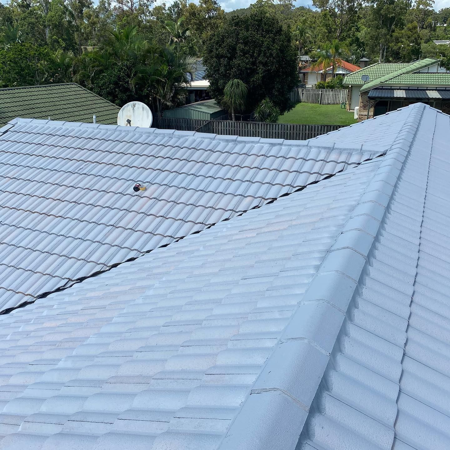 Light Blue Tiled Roof of a House, With a Satellite Dish — SEQ Roofing & Painting in Surfers Paradise, QLD