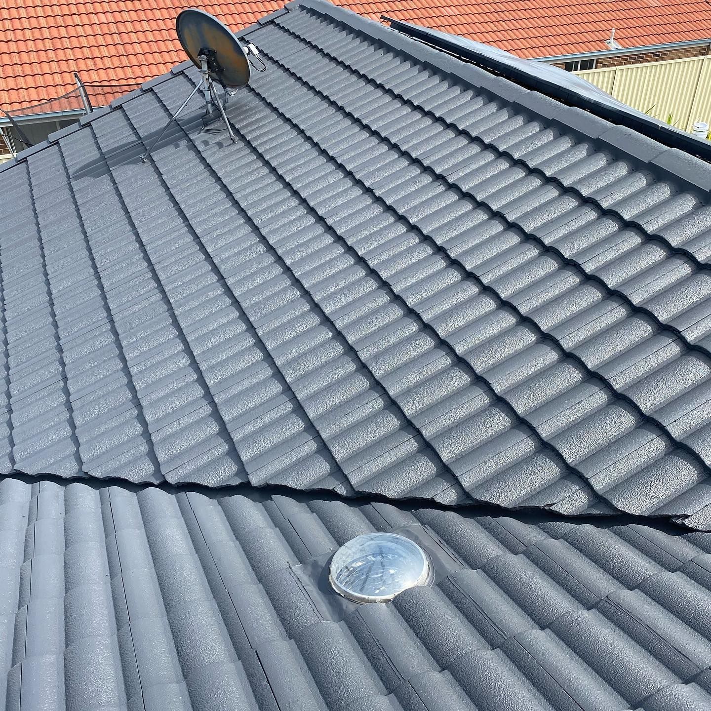 Gray Metal Roof with Ribbed Texture, a Satellite Dish, and A Skylight — SEQ Roofing & Painting in Southport, QLD