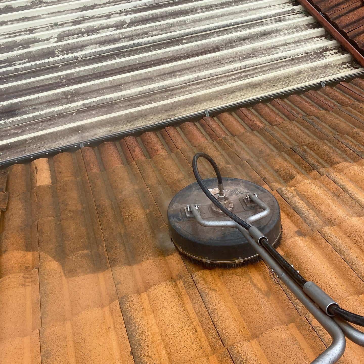 Pressure Washer Cleaning a Red Tile Roof — SEQ Roofing & Painting in Nerang, QLD