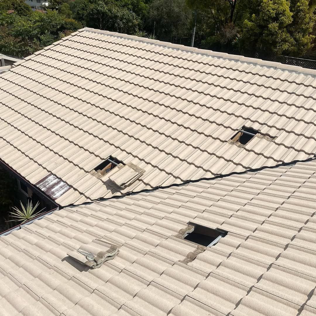 Beige Tile Roof With Several Holes and Surrounding Trees — SEQ Roofing & Painting in Southport, QLD
