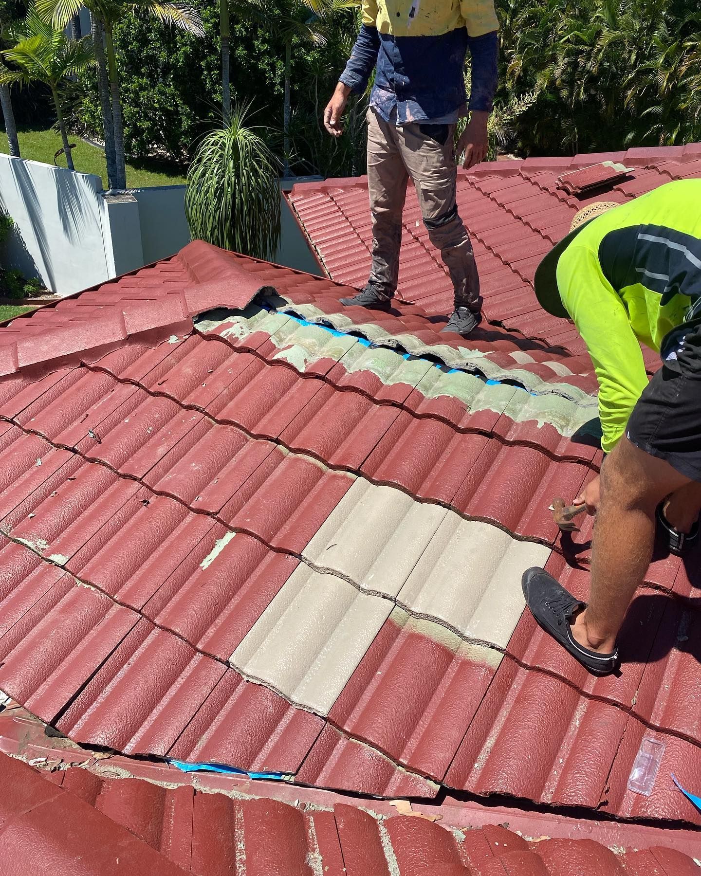 Two Workers on A Red Tiled Roof, Replacing Cream-Colored Tiles — SEQ Roofing & Painting in Nerang, QLD