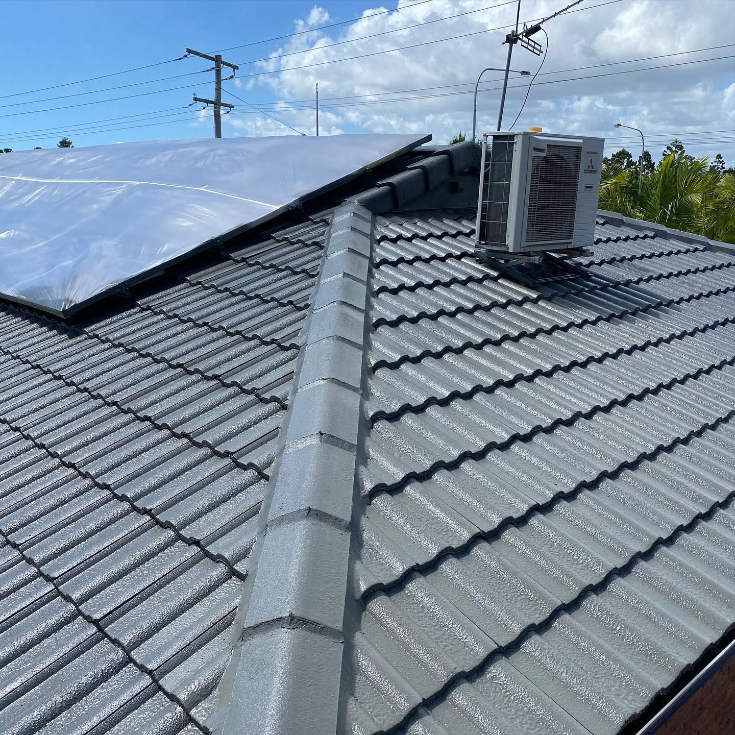 Gray Tiled Roof with Solar Panels and An Air Conditioning — SEQ Roofing & Painting in Southport, QLD