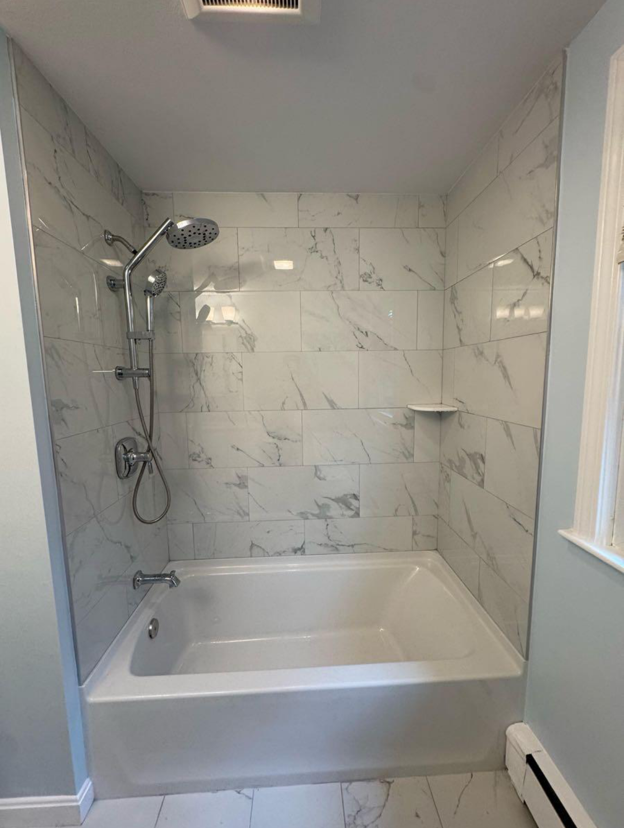 Contractor consulting with a homeowner on bathroom remodeling tile selections