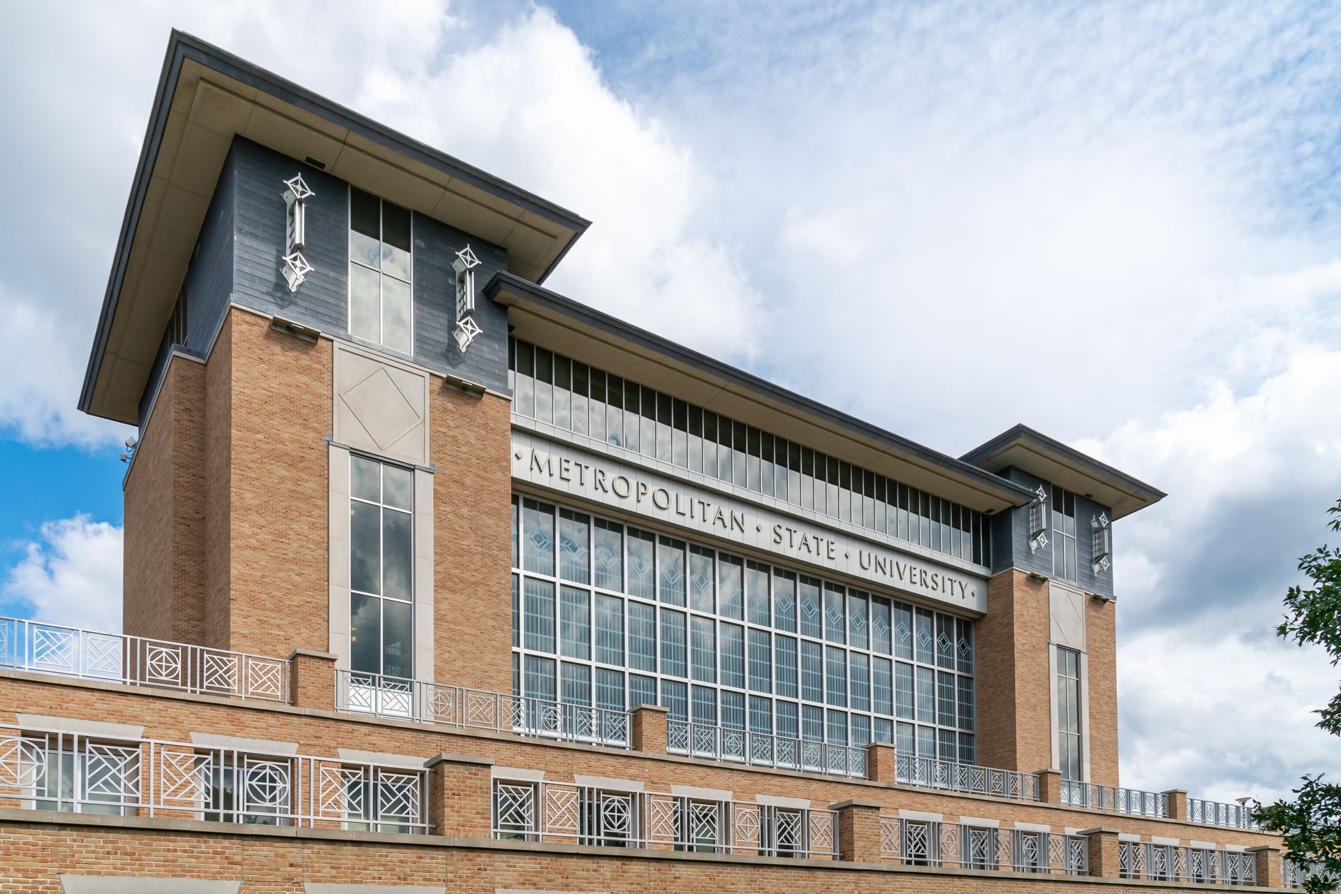 A large brick building with a lot of windows and the word metropolitan on it