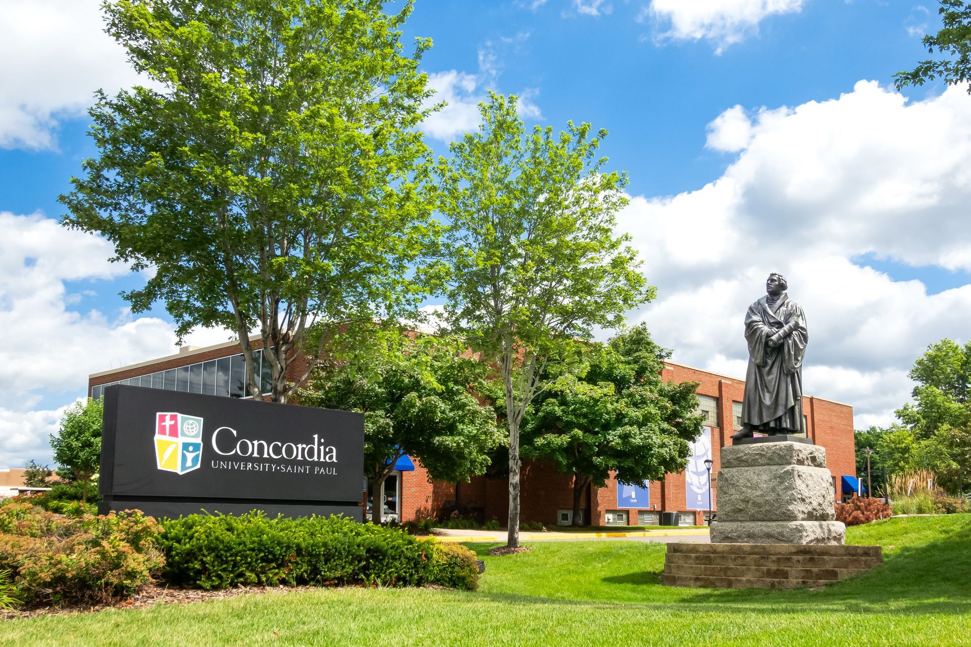 A statue is in front of a concordia building
