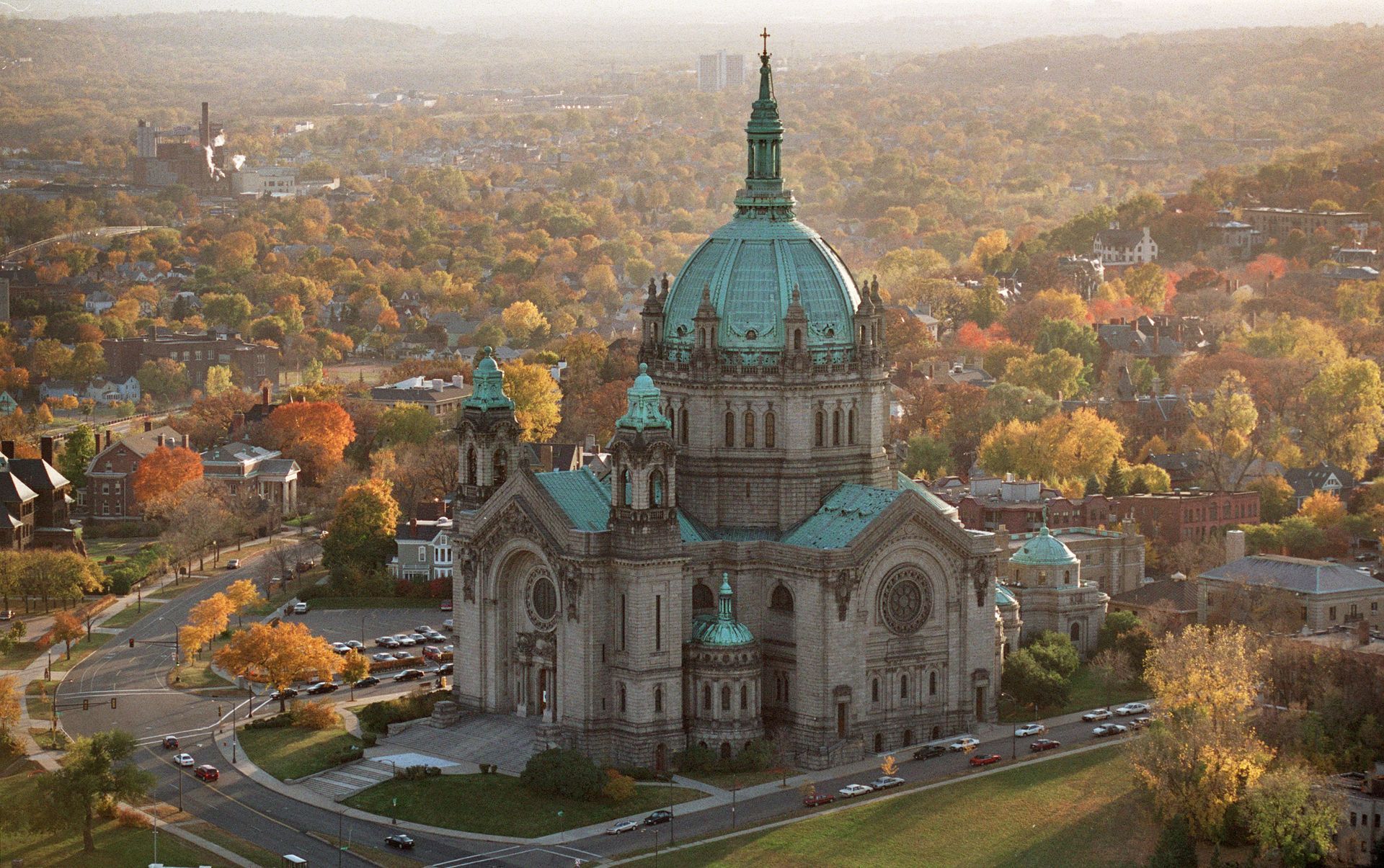An aerial view of a large building with a dome in the middle of a city.