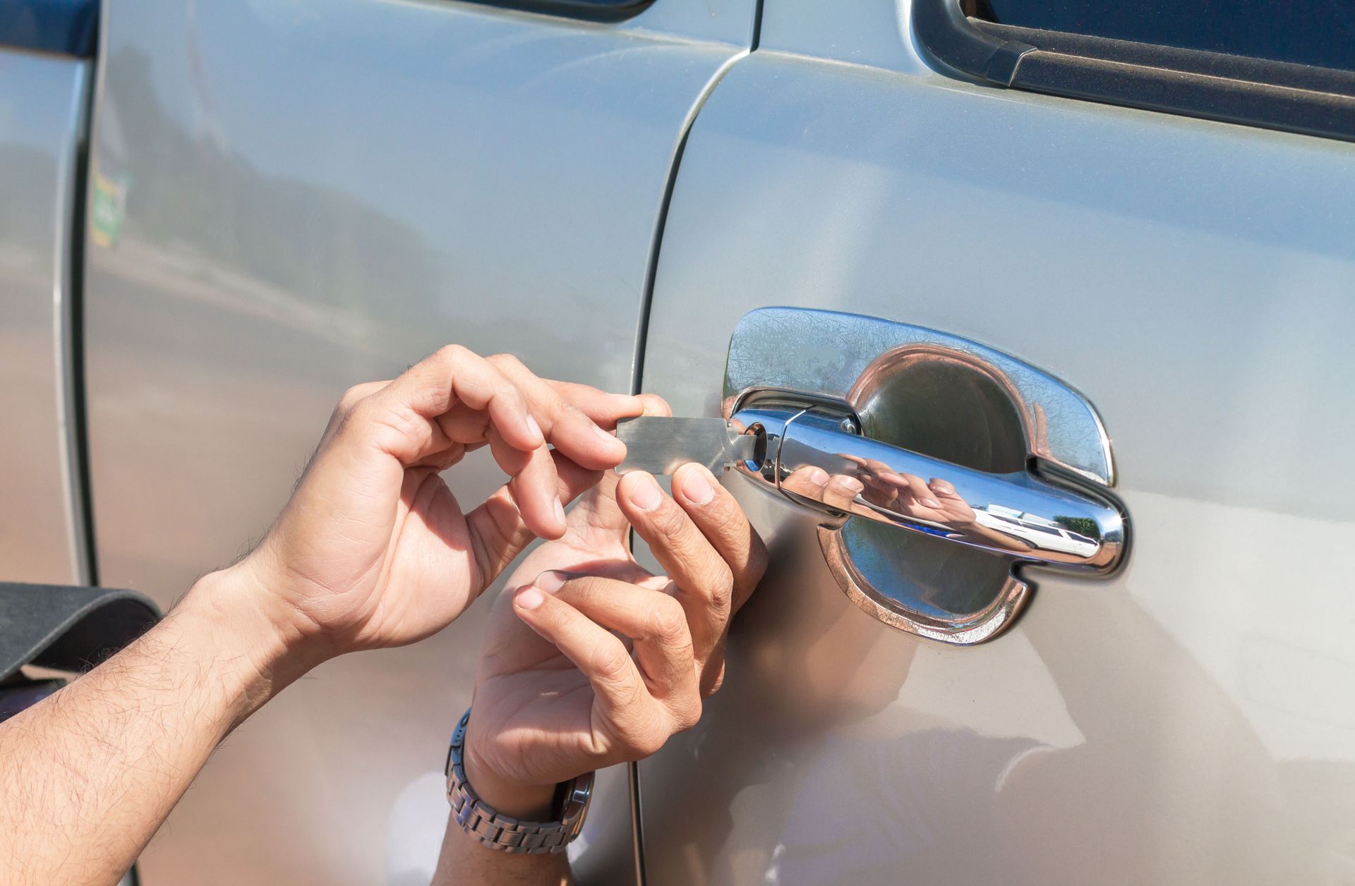A Person is Trying to Open a Car Door With a Key