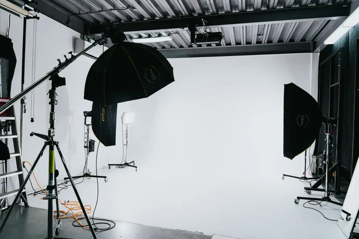 AI Studios photography space with a white cyclorama and studio lights
