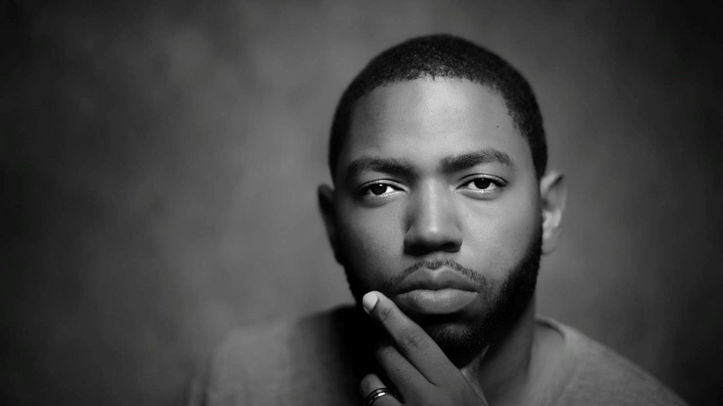 Black-and-white portrait of Conrad Baird featured in Trinidad Guardian