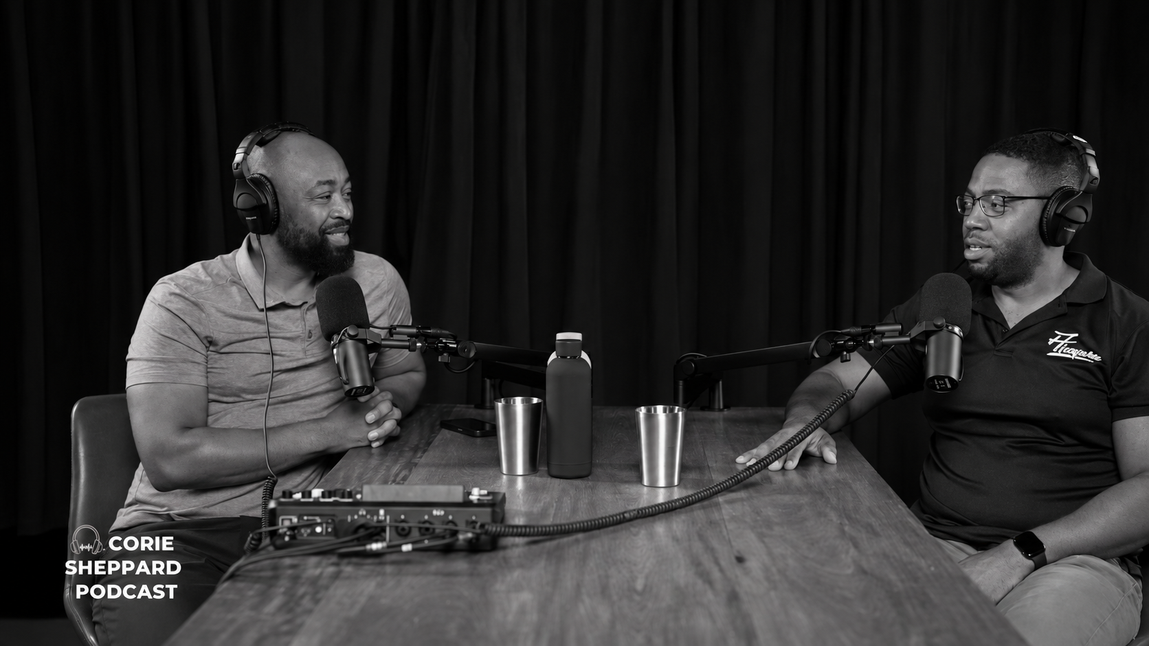 Conrad Baird and Corie Sheppard speaking at microphones during their podcast interview
