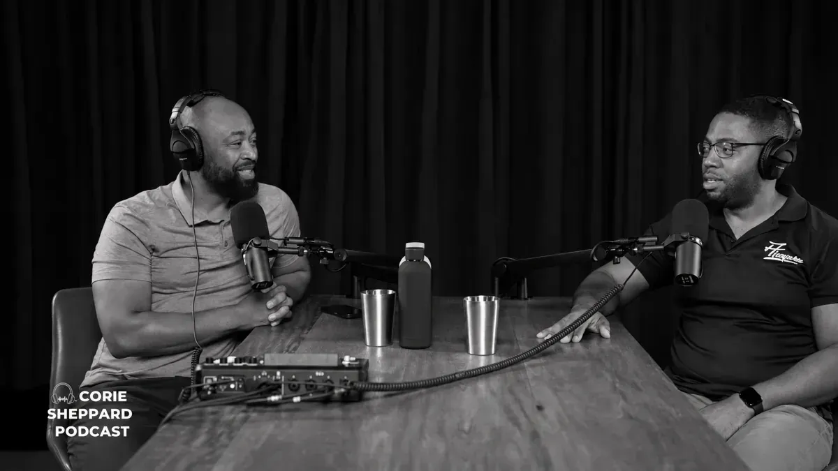 Conrad Baird and Corie Sheppard speaking at microphones during their podcast interview