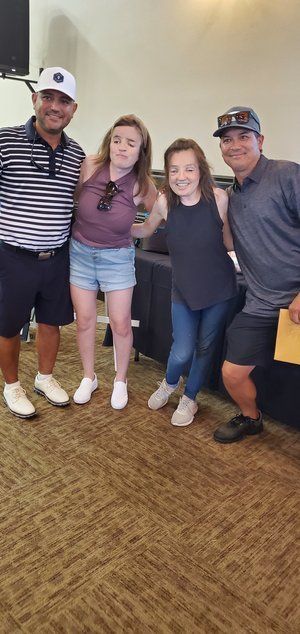 A group of people are posing for a picture together in a room.