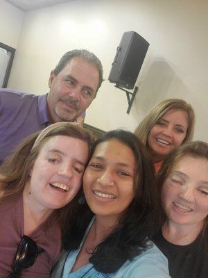 A group of people are posing for a picture together and smiling.