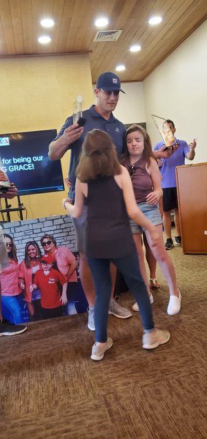 A group of people are dancing in a room.