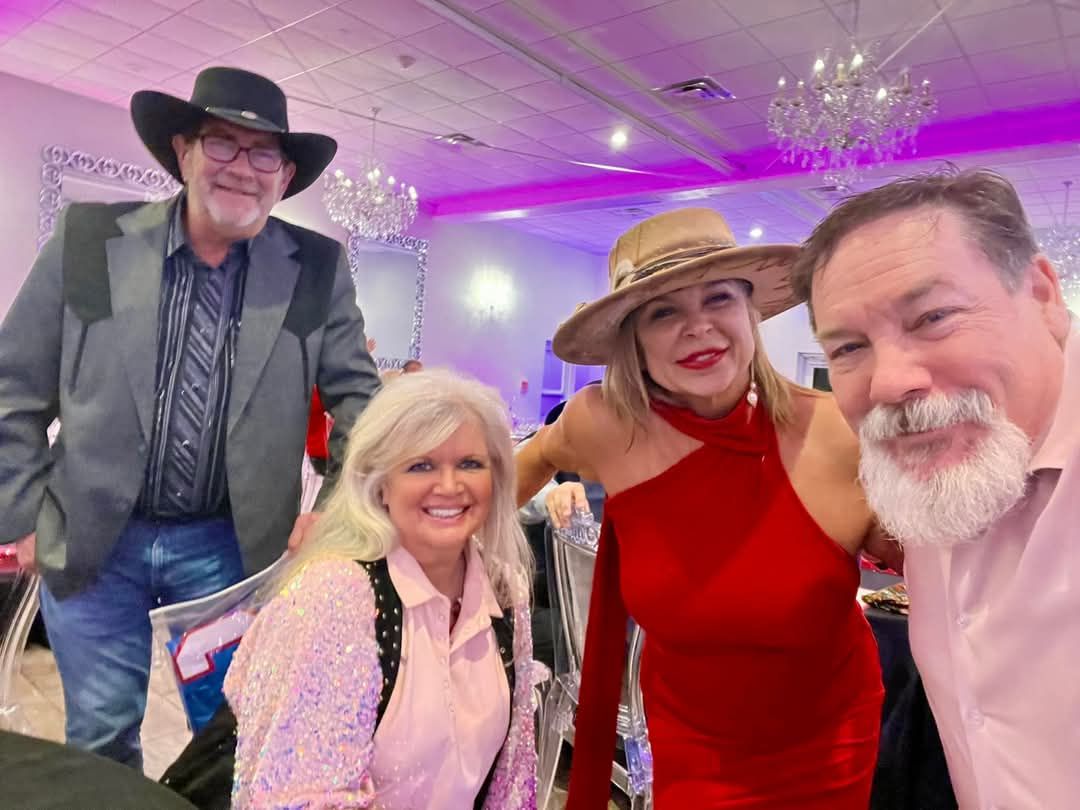 A group of people are posing for a picture in a room.
