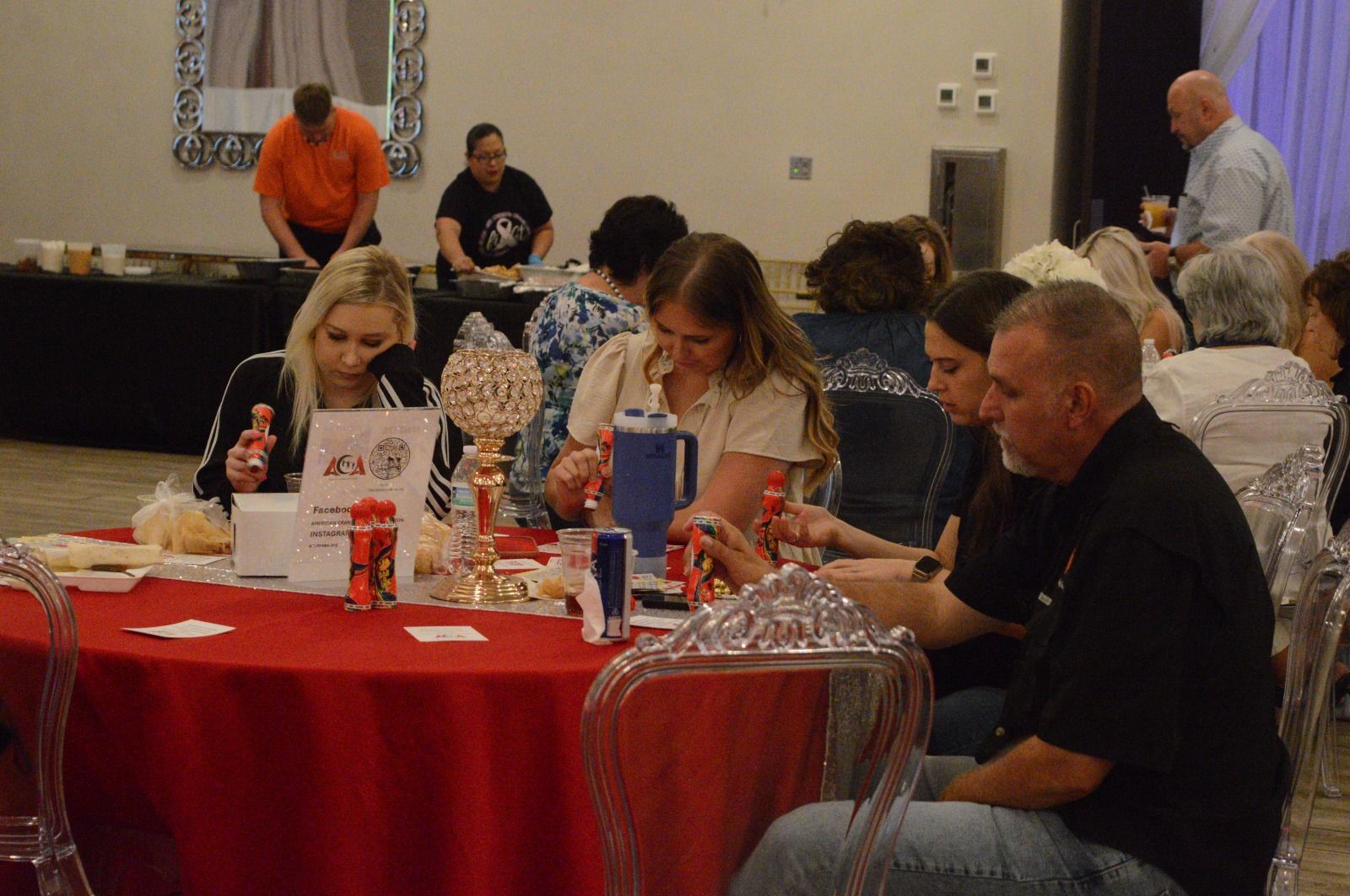A group of people are sitting at tables in a room.