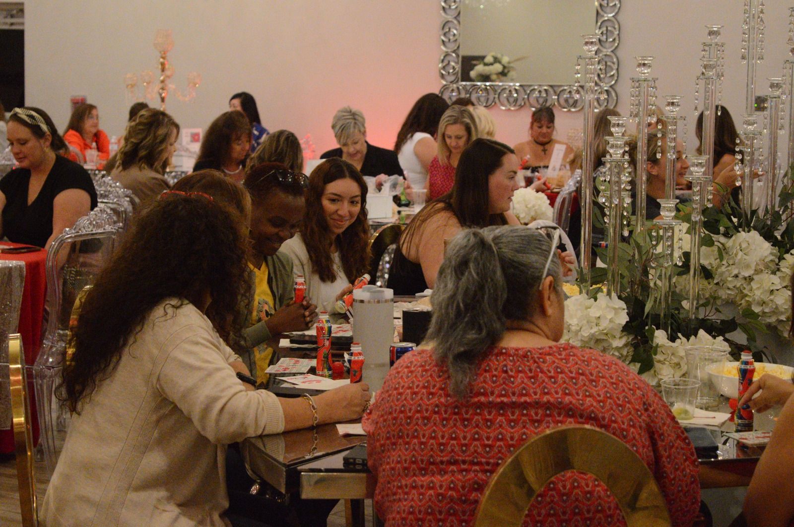 A group of people are sitting at tables in a room.