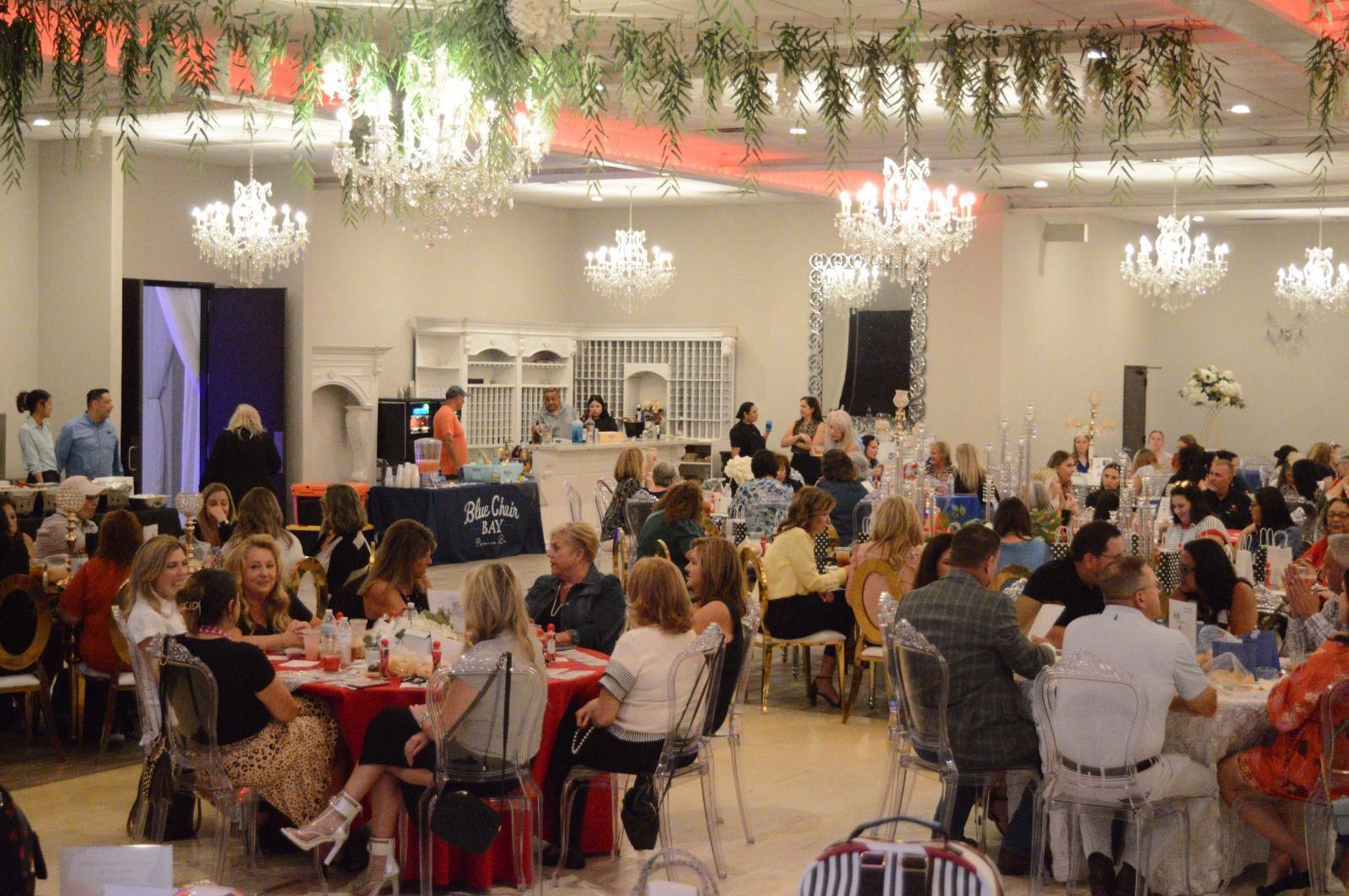 A large group of people are sitting at tables in a large room.