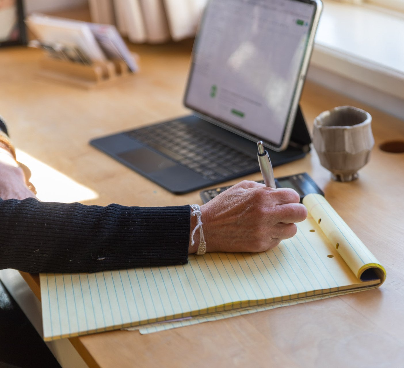 man sitting at desk, and looking at his computer