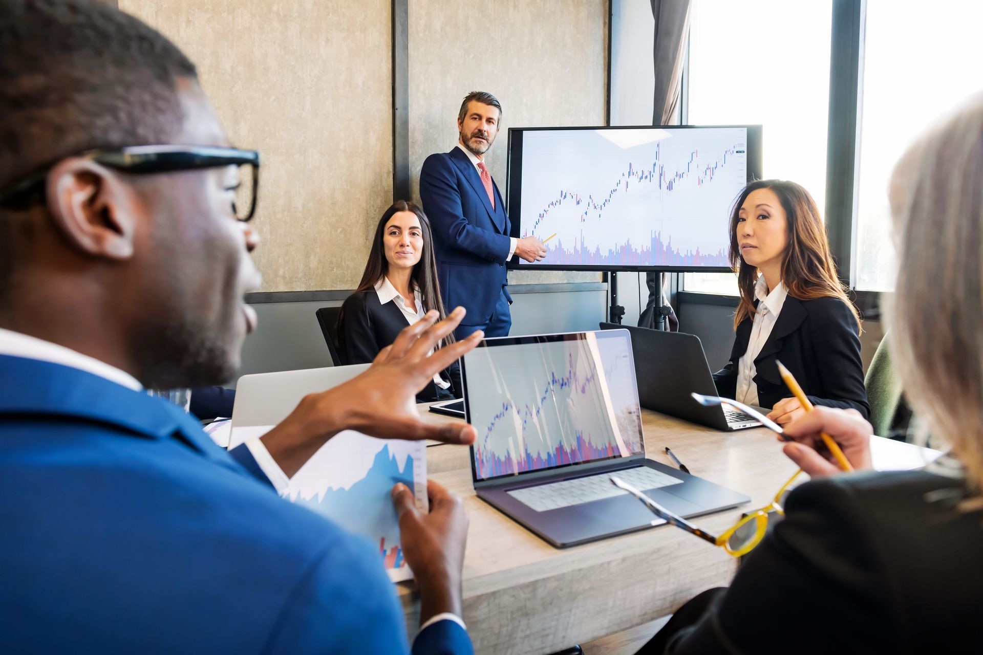 A group of business people are having a meeting in a conference room.