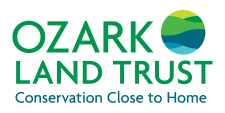 Ozark Land Trust logo with green text and a circular graphic of layered green and blue hills; tagline “Conservation Close to Home.”