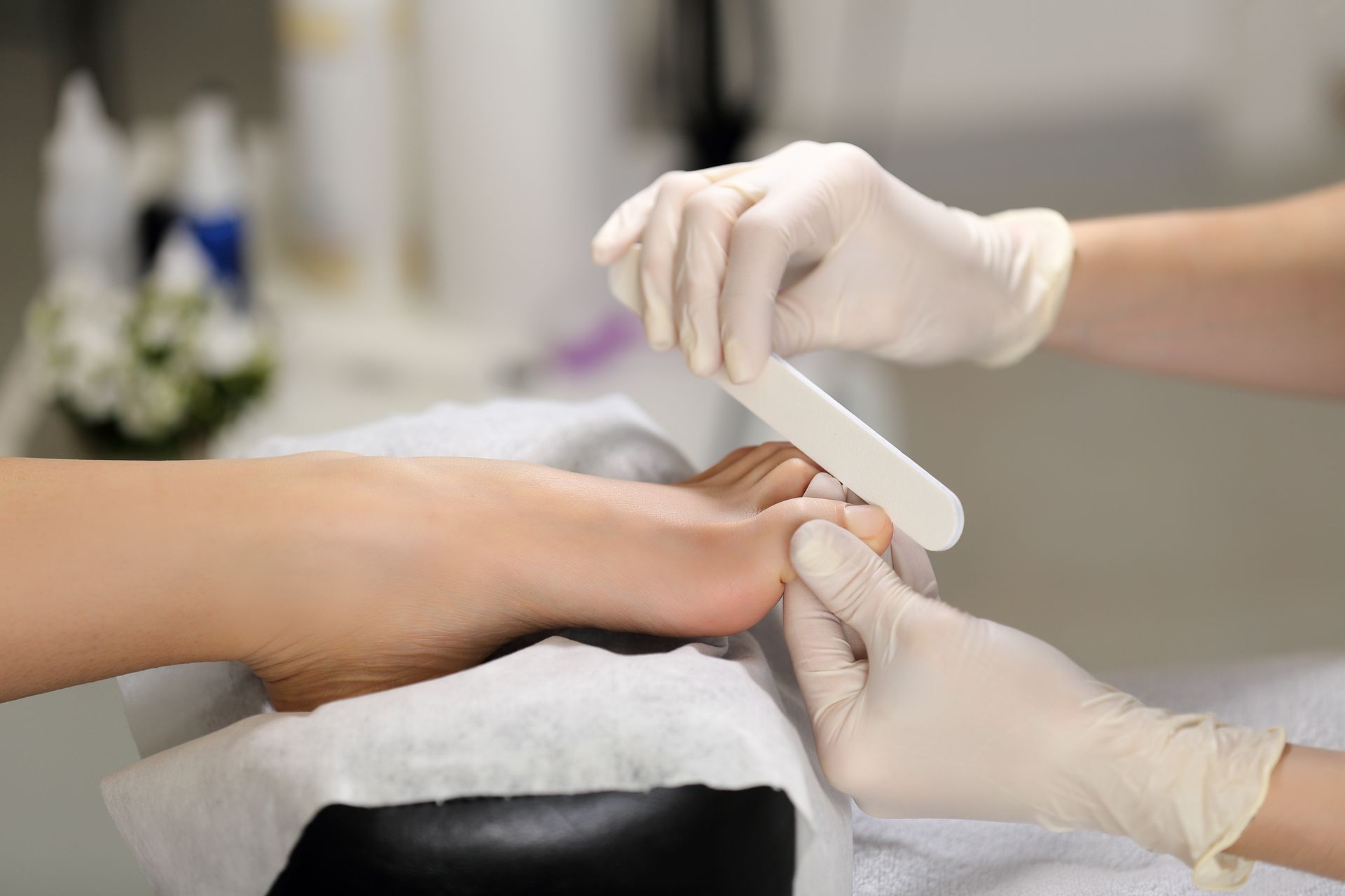 Eine Frau lässt sich in einem Nagelstudio die Nägel machen.