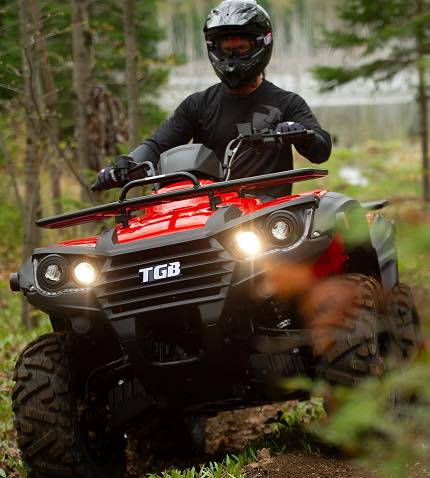 Man Riding Red TGB Quad Bike — Quad Bikes in North Lismore, NSW