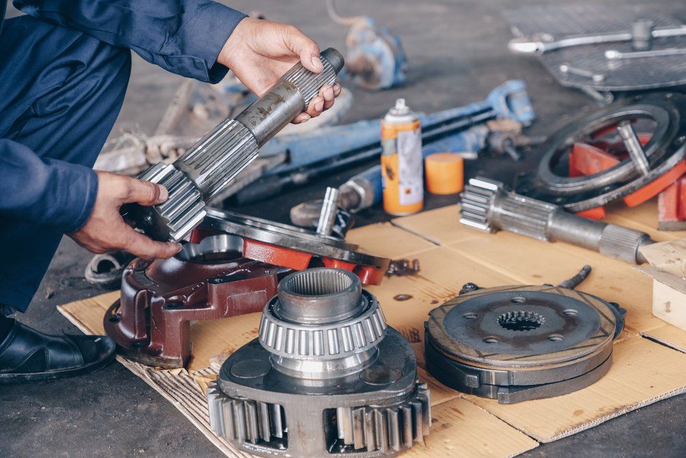 Mechanic Holding Tractor Parts — Tractor Repairs in North Lismore, NSW