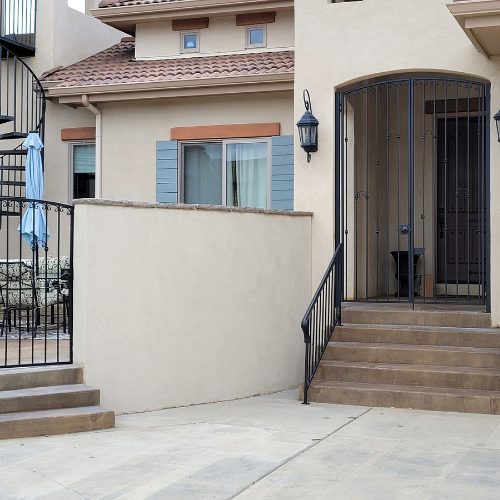 A house with a spiral staircase leading up to the front door