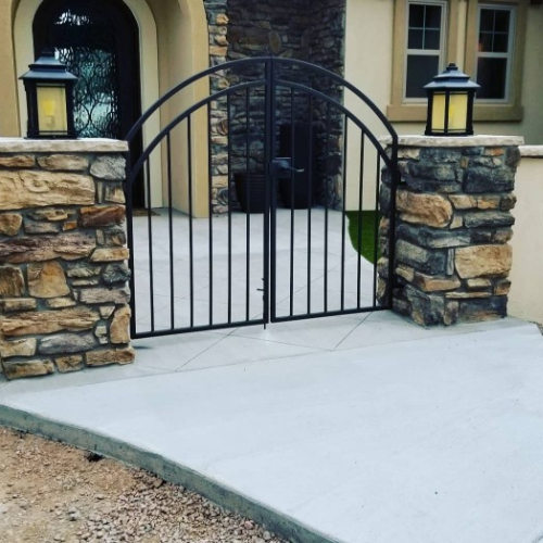 A stone wall with a gate in front of it