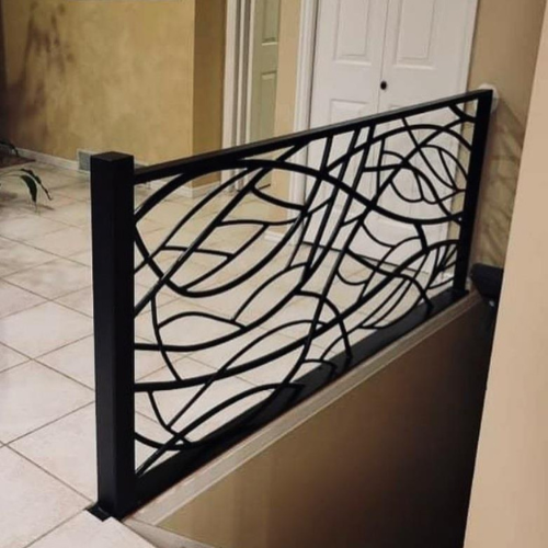 A black railing with a leaf design on it