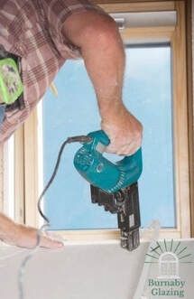 Burnaby Window Installation contractor cutting out a retrofit window with a power saw.