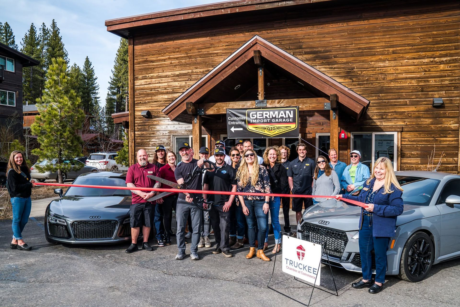 Group Gathered For A Ribbon Cutting Outside The Shop | German Import Garage