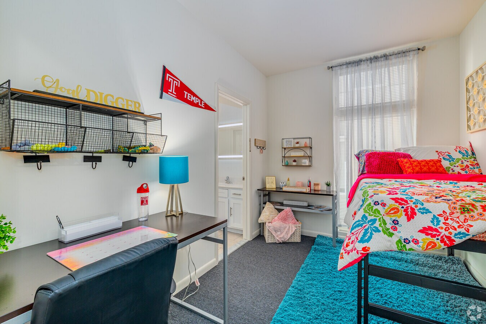 Student bedroom with desk and colorful bedding at Temple Crossing