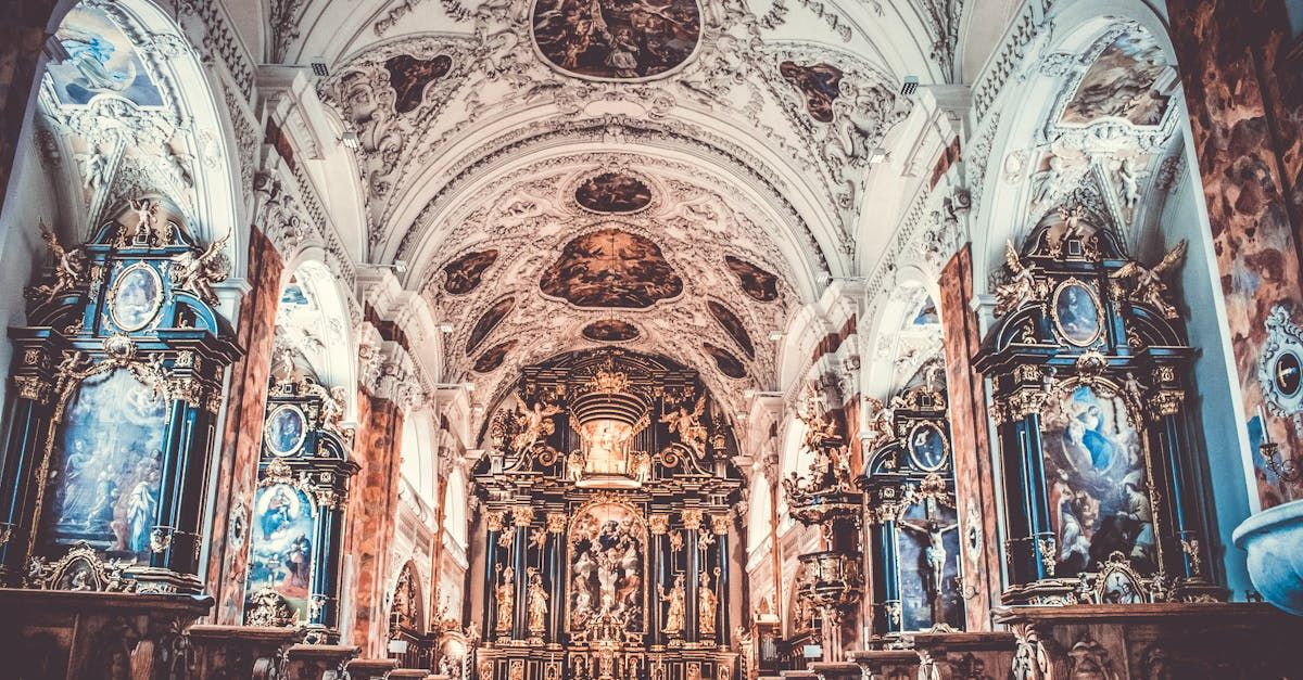 The inside of a church with a very ornate altar.