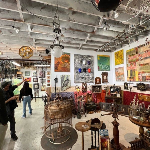 A room filled with lots of paintings and clocks