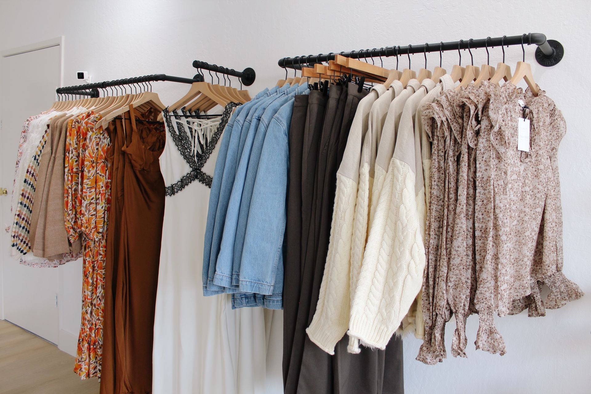 A row of clothes hanging on a rack in a store.