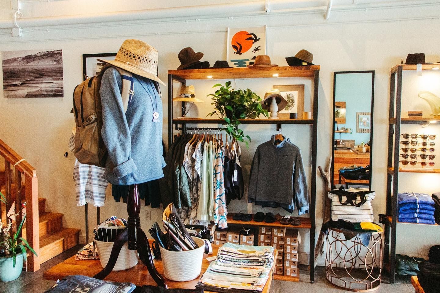 A clothing store with a mannequin wearing a hat and a backpack.