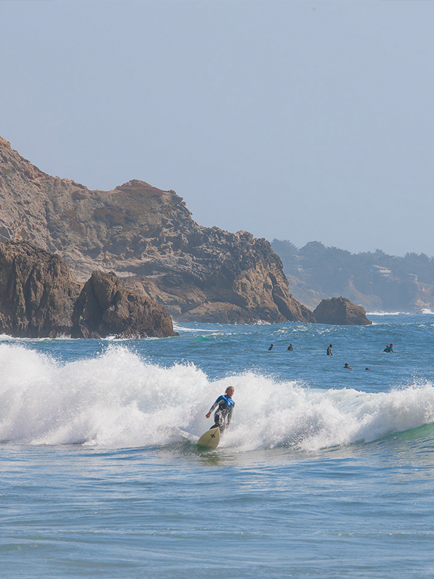 A man is riding a wave on a surfboard in the ocean