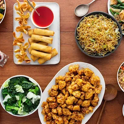 There are many different types of chinese food on the table.